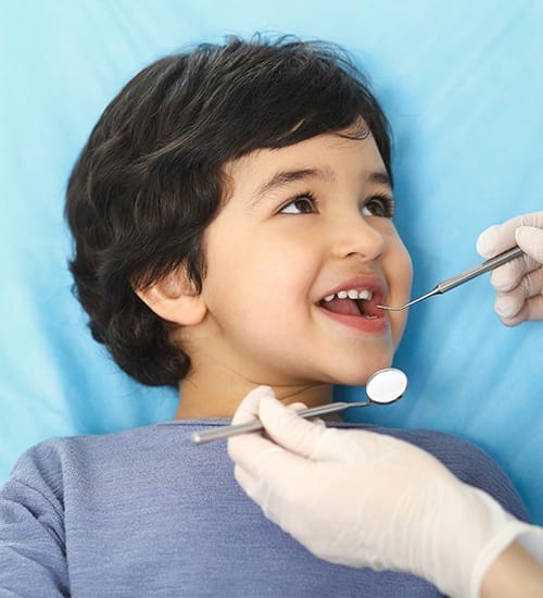 Young child receiving dental exam at first visit