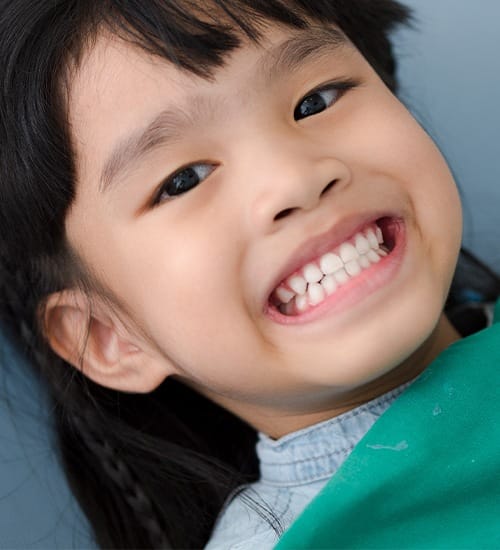 Child smiling after silver diamine fluoride treatment