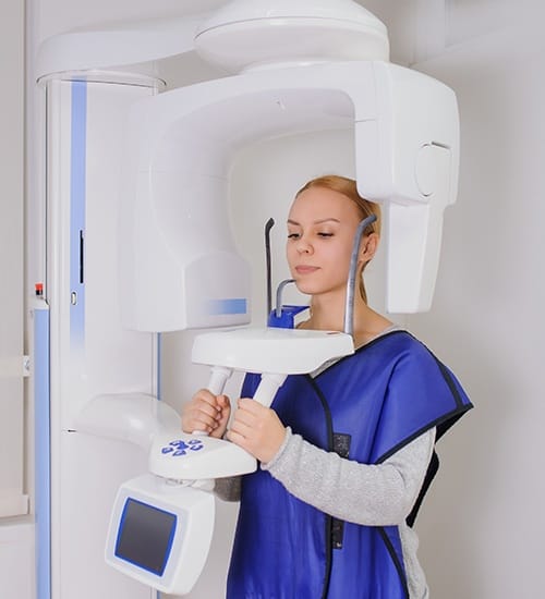Woman receiving 3 D C T cone beam x-ray scans
