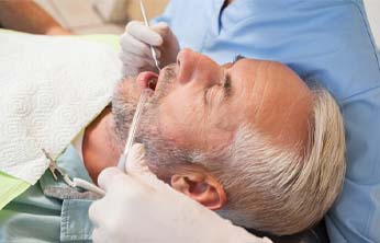 Older man laid back in dental chair during checkup