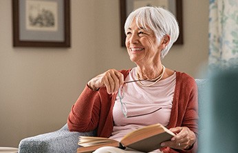 Senior woman sitting in chair smiling
