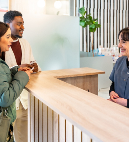 Couple paying for dental treatment 