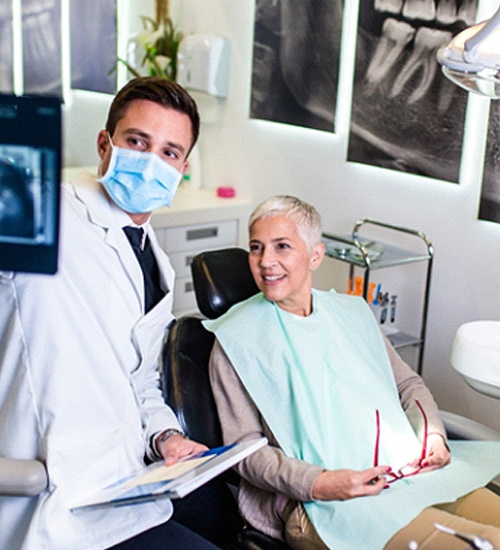 Dentist showing patient an X-ray of her smile