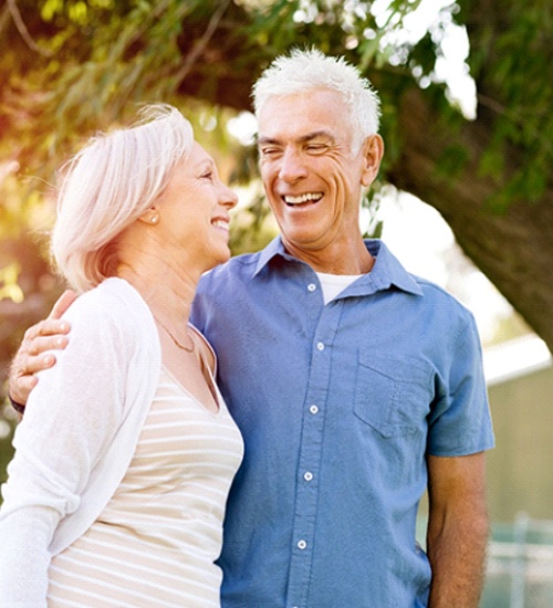 Older couple smiling together while outside