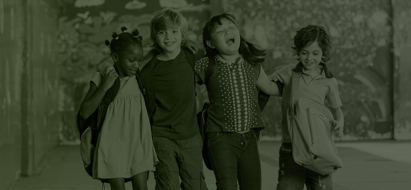 Four kids laughing together after children's dentistry visit