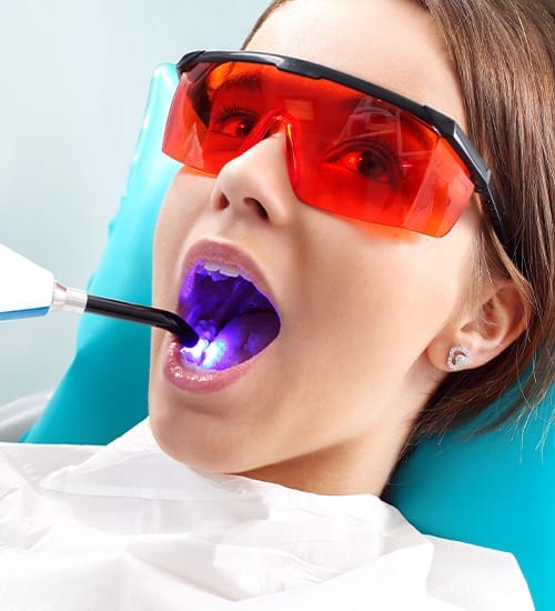 Child receiving dental sealant treatment