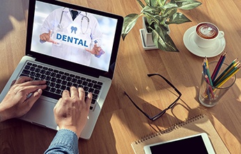 Using computer to research dental insurance benefits for dentures