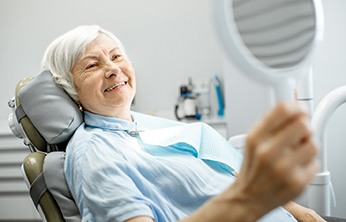 Senior woman happy she could afford her new dentures