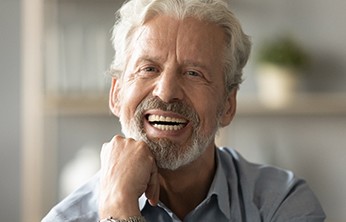 Bearded man sitting and smiling at home