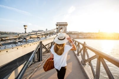 Person walking across a scenic bridge