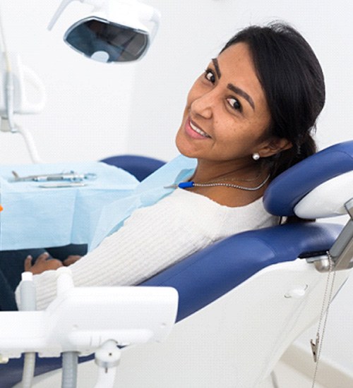 Woman sitting in dental chair waiting for dentist