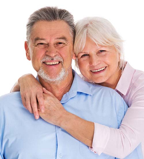 Older couple smiling with arms around each other