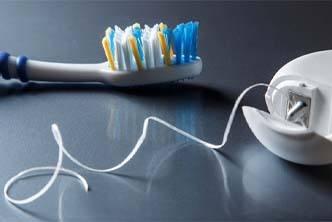 Closeup of toothbrush and dental floss