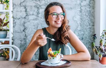 Woman at table eating a healthy snack