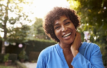 smiling woman standing outside