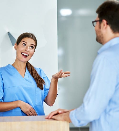 Dental team member discussing dental insurance coverage with patient