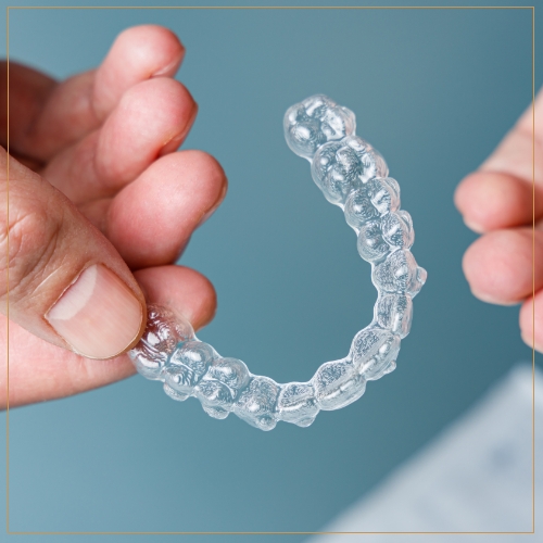 Person holding invisalign aligner 