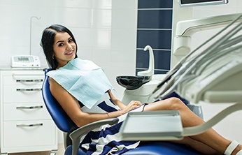 Woman smiling while sitting in dental chair