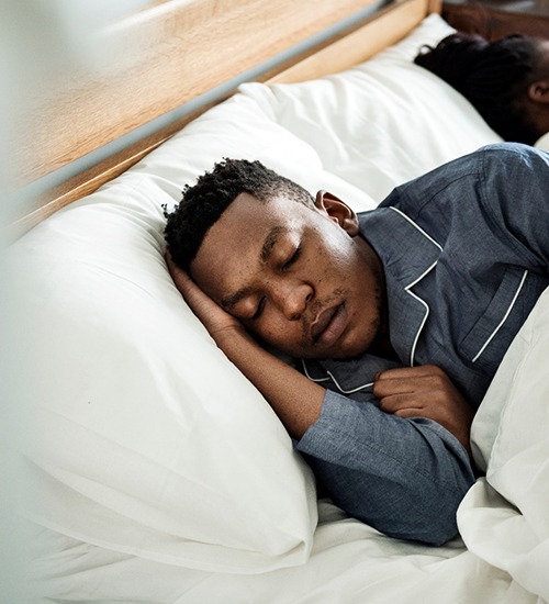 Close-up of a man sleeping soundly in bed