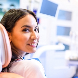 Woman looking back while sitting in the dental chair