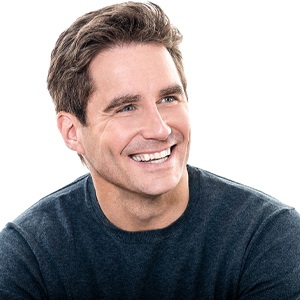 Man in sweater smiling with white background