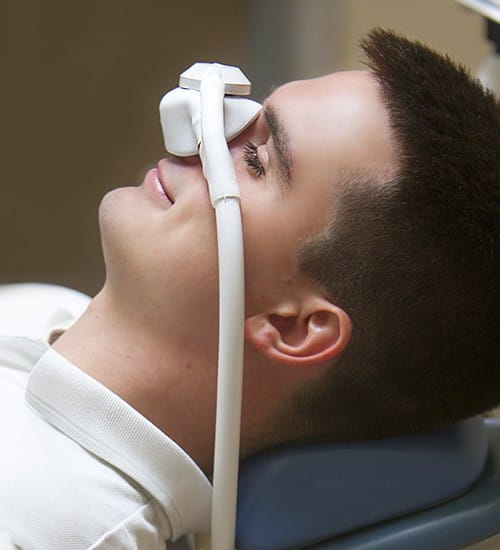 Relaxed patient with nitrous oxide dental sedation mask