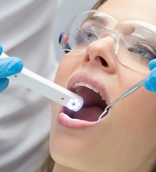 Dentist using intraoral camera to capture images of a patient's smile