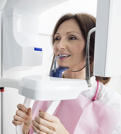 Woman receiving C T cone beam scanner