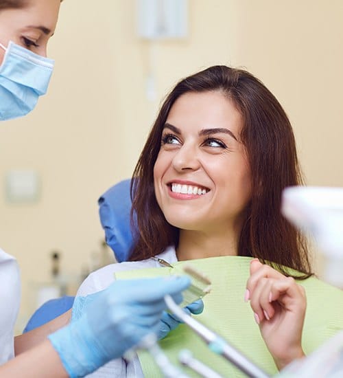 Woman discussing teeth whitening options with dentist