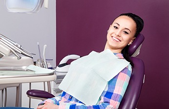 Female patient leaning back in chair and smiling