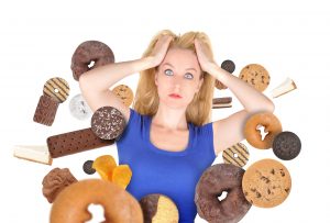 Woman battling sugary foods. 