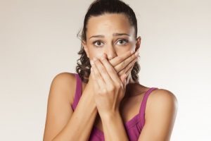 Woman covering her mouth. 