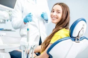 Woman smiling free of cosmetic dental flaws