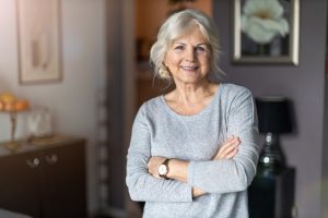 Woman smiling after caring for dentures