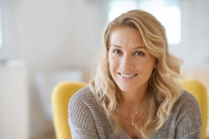 Woman smiling after learning more about American Heart Month