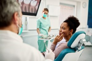 Woman touching her cheek because of dental pain