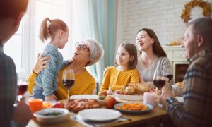 family eating Thanksgiving dinner and being thankful for their teeth