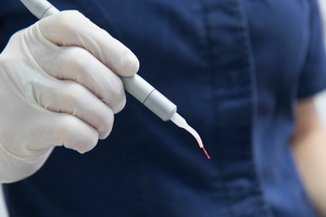 Close-up of hand holding a soft tissue laser