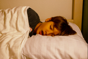 Little boy with sleep apnea snoring in bed